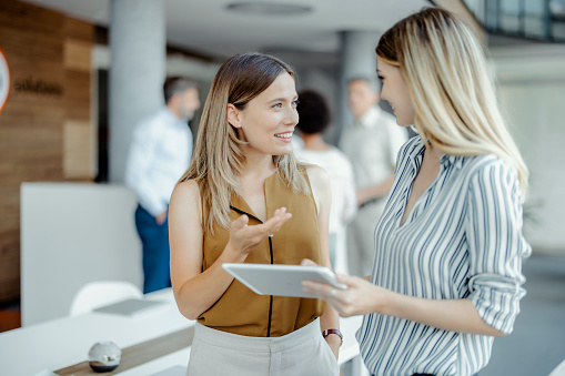 Happy confident mature businesswoman speaking, negotiating on deal at meeting, discussing project with customers, business partners. Lawyer giving consultation to clients. Employer at job interview