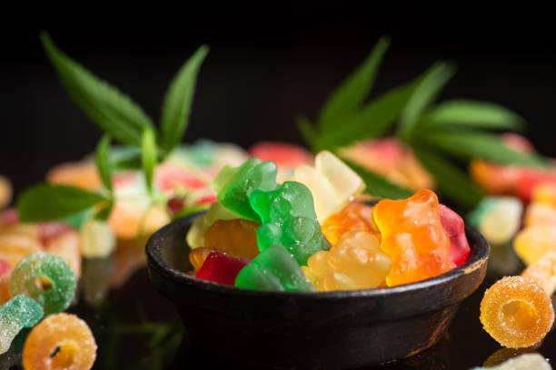 Colored candy gelatin with marijuana leaves stock photo