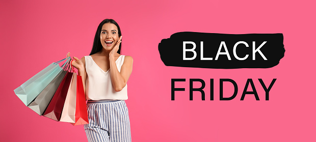 Black Friday Sale. Beautiful young woman with shopping bags on pink background, banner design