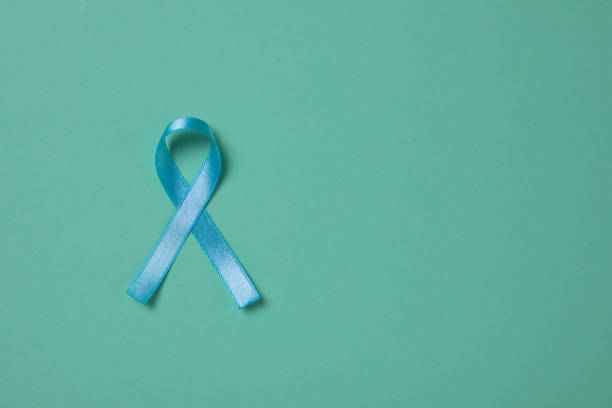 istock Light blue awareness ribbon on turquoise background, top view. Space for text 1406181792