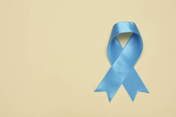 istock Light blue awareness ribbon on beige background, top view. Space for text 1406181795