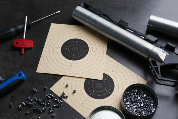 istock Composition with sport pistol on black table. Professional gun 1406182151