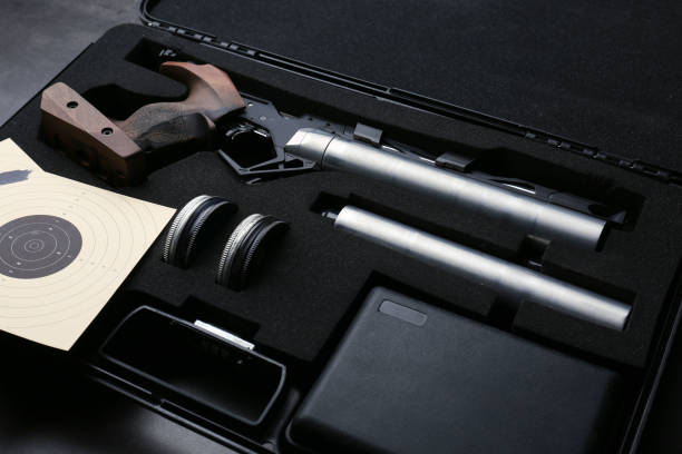 istock Case with sport pistol and accessories on black table. Professional gun 1406182399