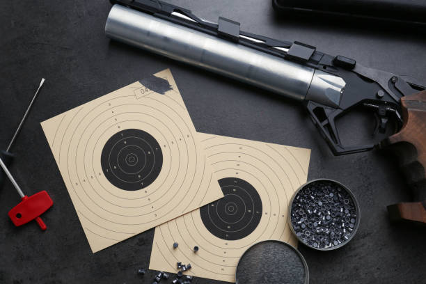 istock Flat lay composition with sport pistol on black table. Professional gun 1406182983