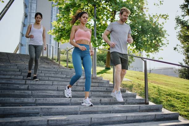 istock Focussed group of runners jogging on stairs 1406183007