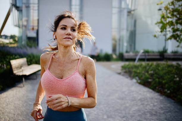 istock Woman on a morning run with her friends 1406183031
