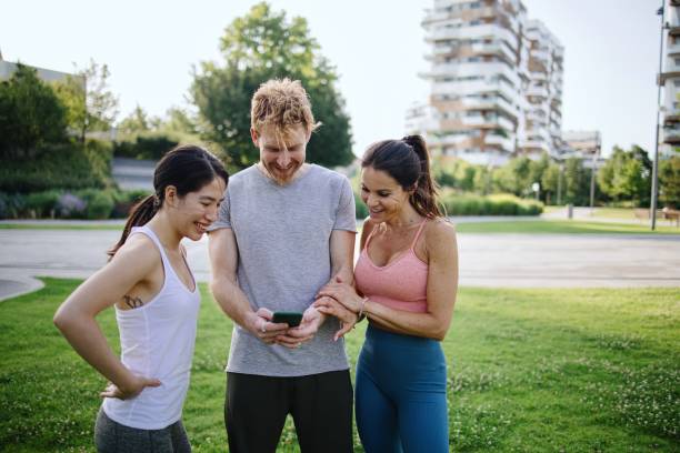 istock Fitness friends looking at the phone during break 1406183166