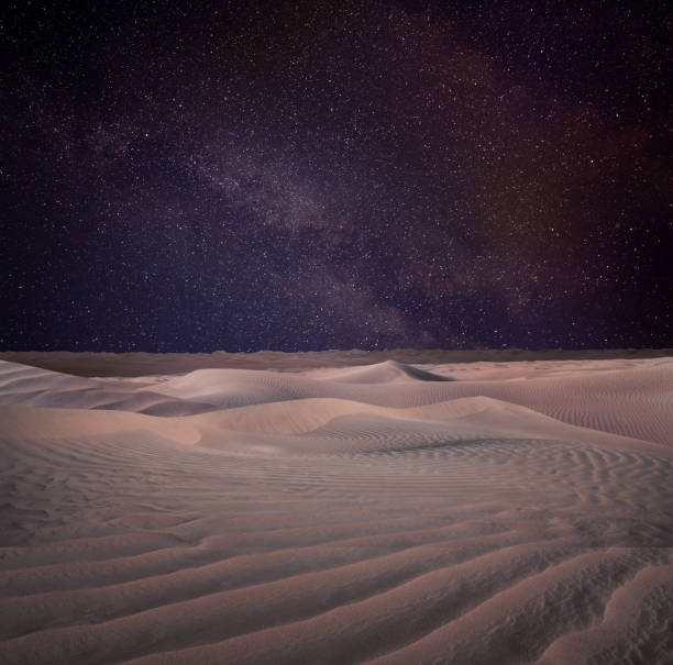 istock Scenic view of sandy desert under starry sky in night 1406183417