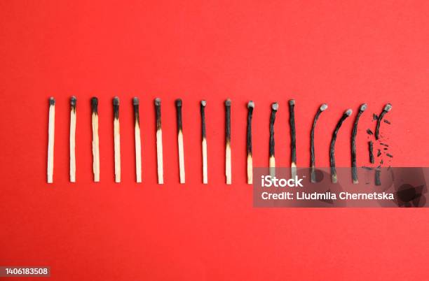 Different Stages Of Burnt Matches On Red Background Flat Lay Stock Photo - Download Image Now