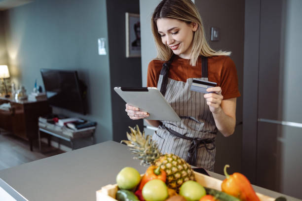 istock Young woman ordering online groceries 1406183650