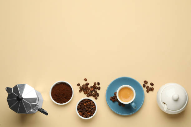 istock Flat lay composition with espresso, ground coffee and roasted beans on beige background, space for text 1406184839