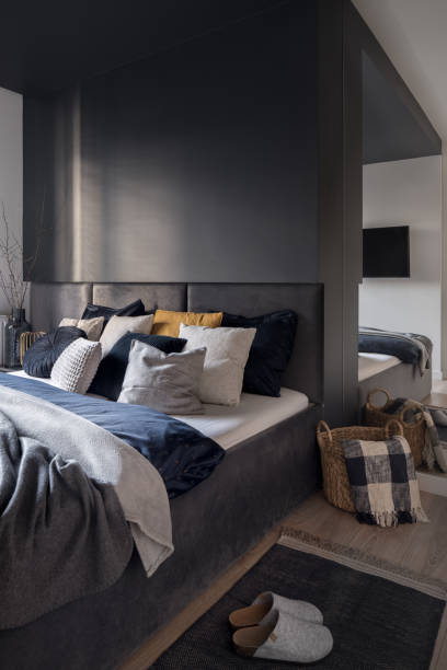 istock Dark and comfortable bedroom with big bed 1406185394