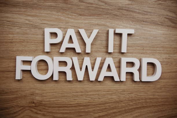 istock Pay It Forward alphabet letters on wooden background 1406185473