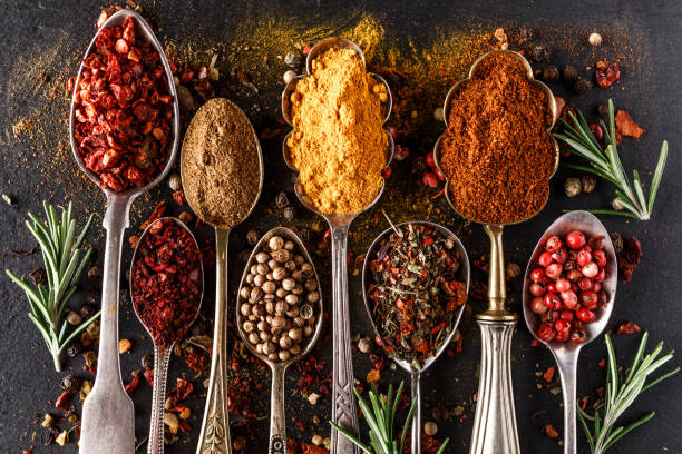 Various spices a vintage spoons on stone table. Colorful Herbal and Spices Oriental marketplace.Top view . Cafe concept. Delicious food delivery. stock photo