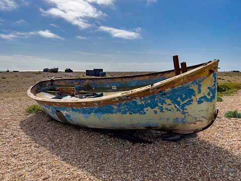 Views of the shingle beach and abandoned fishing boats of Dungeness, with the nuclear power station in the background