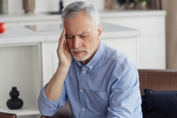 istock Exhausted mature aged man suffering from headache 1406185832