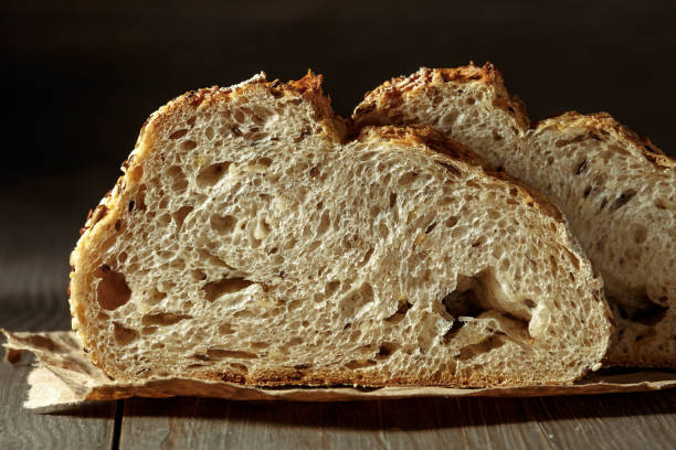 istock Bread, traditional sourdough bread cut into slices on a rustic wooden background. Concept of traditional leavened bread baking methods. Healthy food. 1406186903