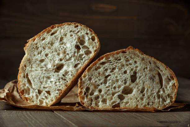 istock Bread, traditional sourdough bread cut into slices on a rustic wooden background. Concept of traditional leavened bread baking methods. Healthy food. 1406186918