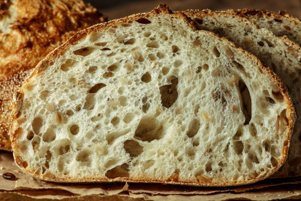 istock Bread, traditional sourdough bread cut into slices on a rustic wooden background. Concept of traditional leavened bread baking methods. Healthy food. 1406186921
