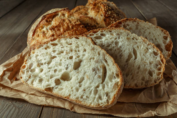 istock Bread, traditional sourdough bread cut into slices on a rustic wooden background. Concept of traditional leavened bread baking methods. Healthy food. 1406186954