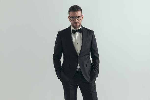 istock handsome businessman holding hands in pockets and posing 1406187518