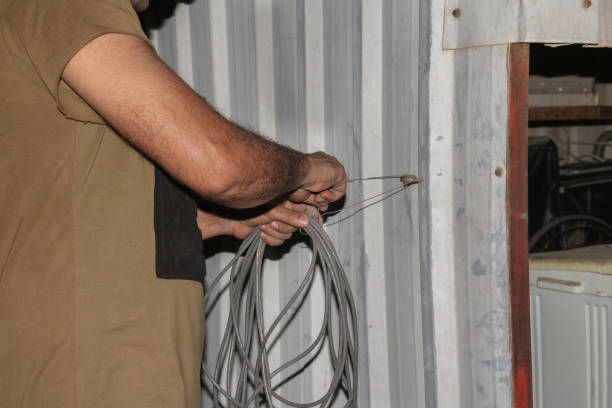 electrician holding wire in working site