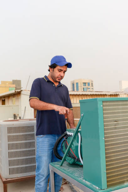 istock a Professional electrician Repairing an air conditioner compressor 1406188520