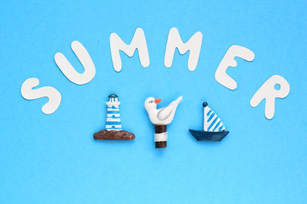 Composition of lighthouse, gull, ship figures and lettering Summer on blue background