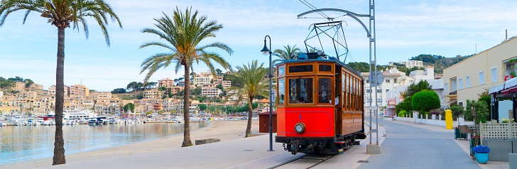 old tram of Port Soller beach with palmas, Mallorca at summer, web banner