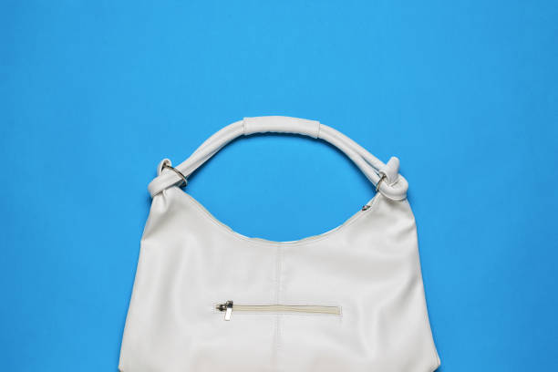 istock White women's leather bag on a blue background. 1406191365