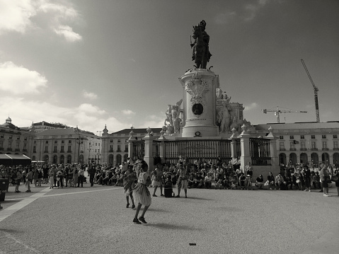 Lisbon, Portugal - May 21, 2022: Street artists dance at the Praça do Comércio square in Lisbon downtown.