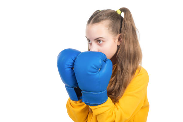 active and healthy childhood. knockout. she will fight. concentrated kid punching. fist to fight. teen girl in boxing gloves. angry attack. child boxer isolated on white background. sport success.