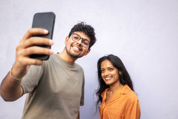 istock Beautiful Indian couple taking a self portrait 1406197008