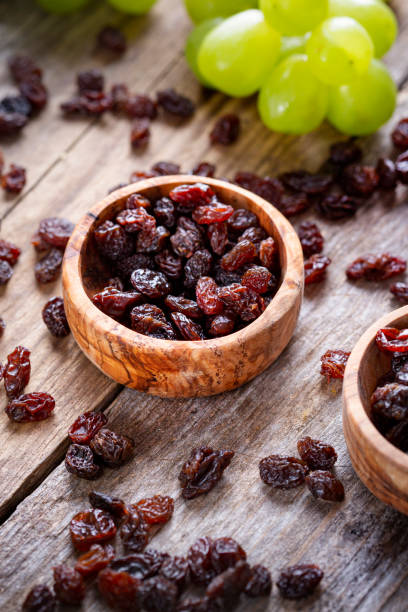istock Raisins and grapes - wooden bowl 1406197955