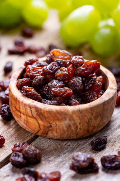 istock Raisins and grapes - wooden bowl 1406197969