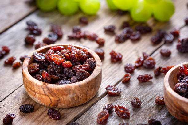 istock Raisins and grapes - wooden bowl 1406197999