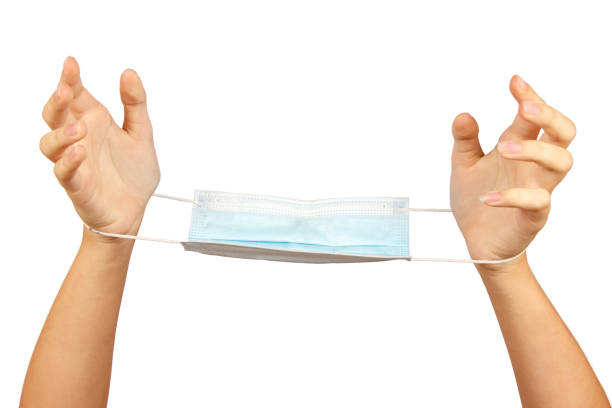 istock female hands with a medical mask 1406205878