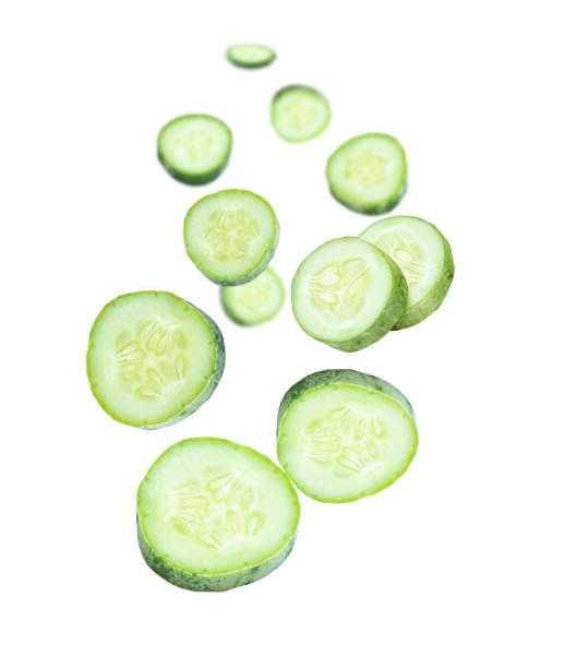 istock Cucumber slice flying in the air isolated on white 1406206466