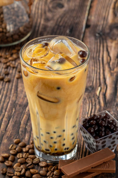 istock Bubble tea with coffee and chocolate in glass cup on dark background. 1406206772