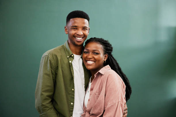 istock Young couple smiling while standing arm in arm together at home 1406208184