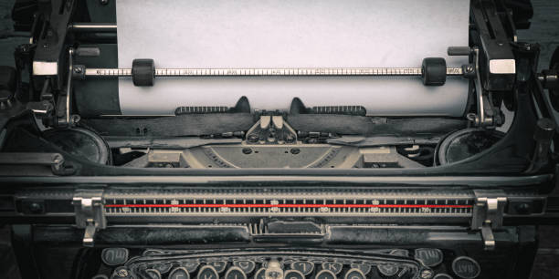 istock Close-up of old typewriter with blank paper - vintage background 1406208200