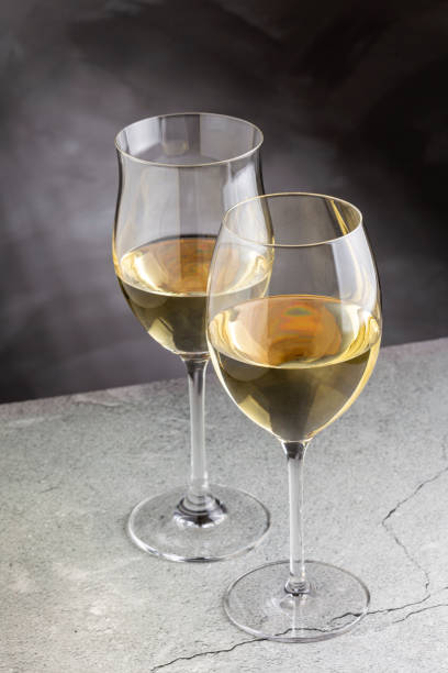 istock Glass of white wine on the table. 1406208470
