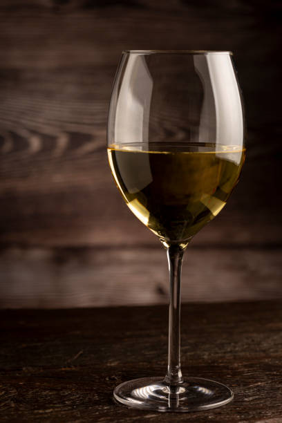 istock Glass of white wine on the table. 1406209373