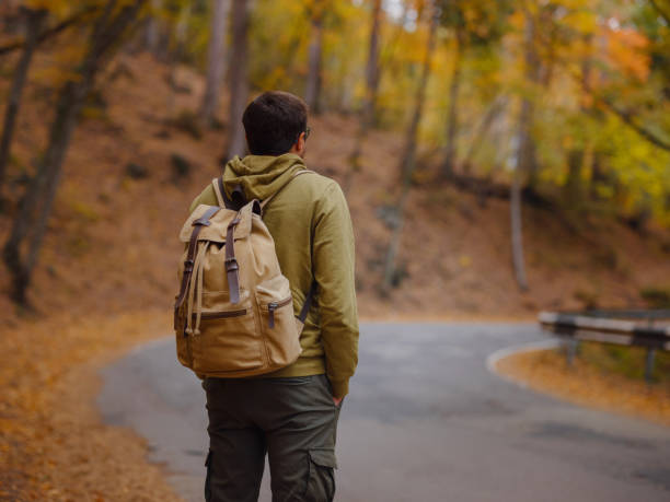 istock Young handsome man posing in autumn forest. 1406209563