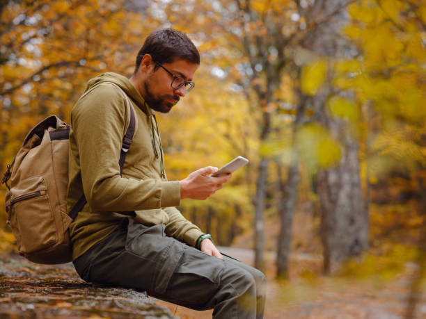 istock Young handsome man posing in autumn forest. 1406211199