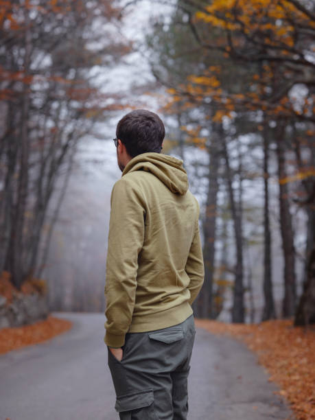 istock Young handsome man posing in autumn forest. 1406212076