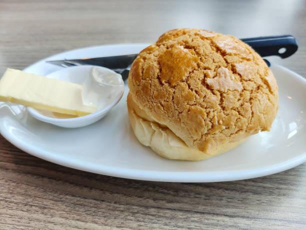Close-up view of a pineapple bun with butter.