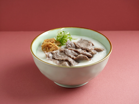 Sliced beef Congee served in a dish isolated on mat side view on grey background