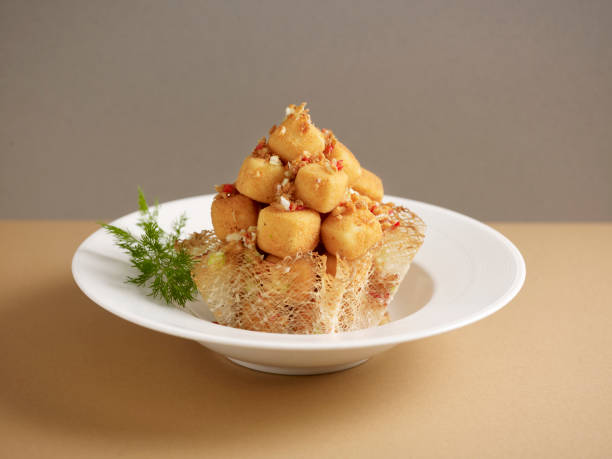 Crispy-fried Tofu with Salt and Pepper served in a dish isolated on mat side view on grey background