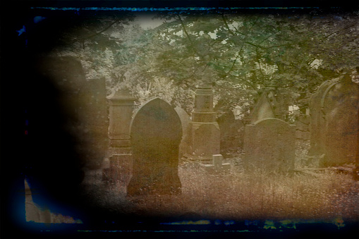 Haworth churchyard with headstones, this is beside the Bronte Parsonage and church where Anne and Charlotte Bronte lived and wrote.  Post processed to give an antique look.
